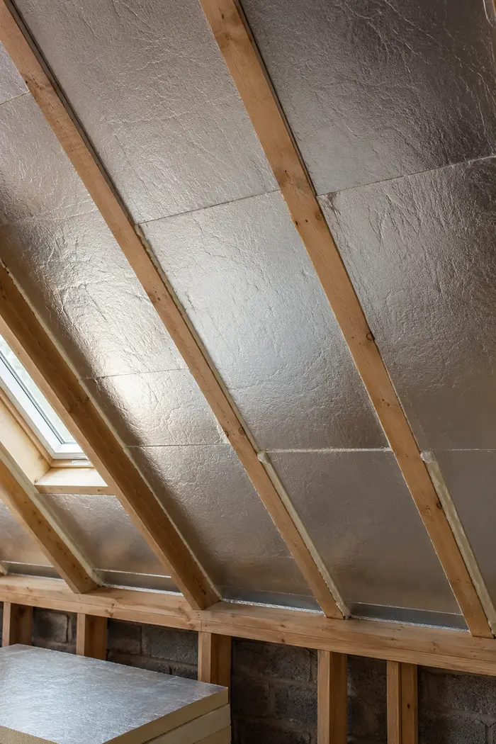 Insulation fitted between rafters in a converted attic